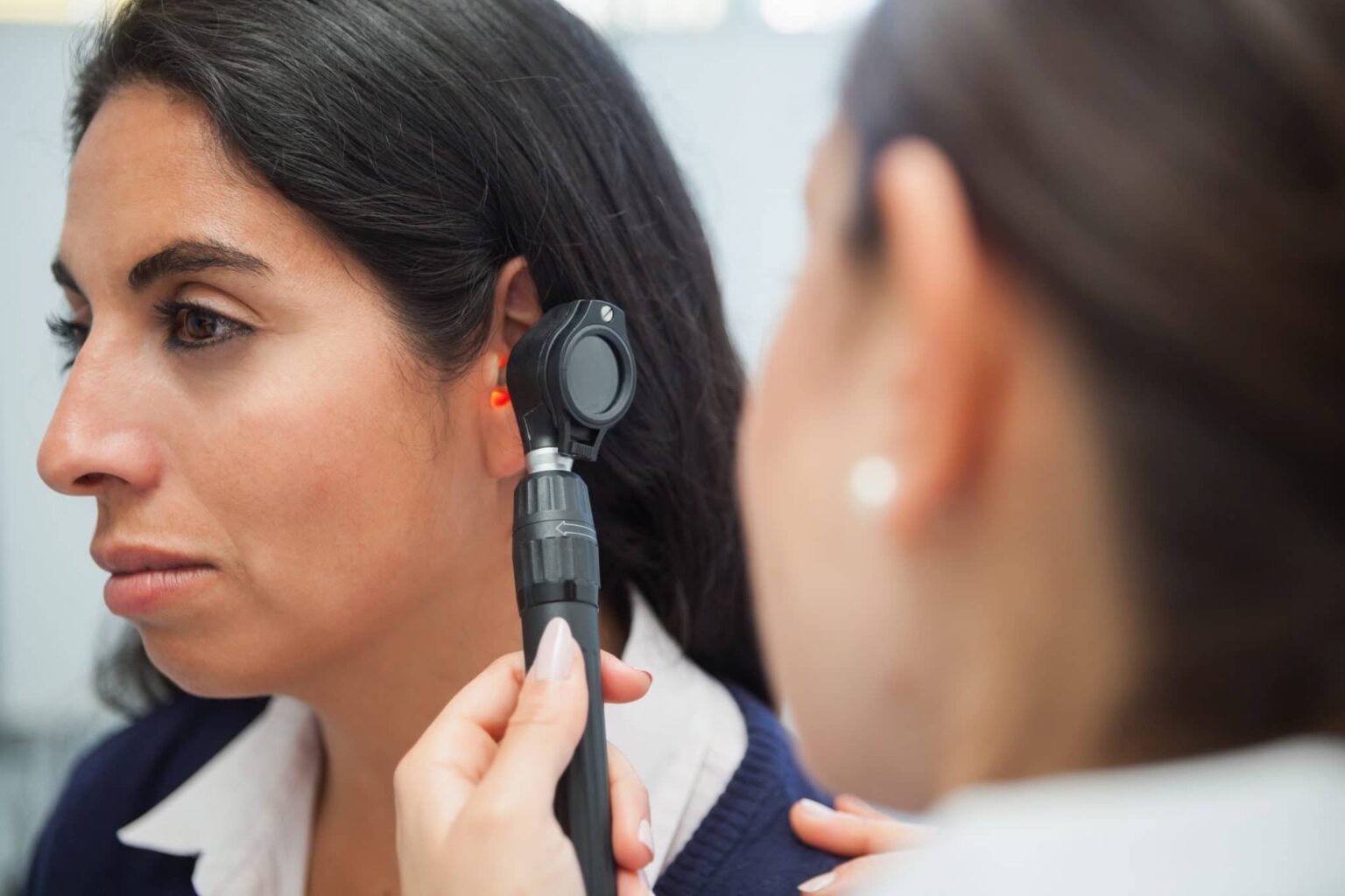 Otolaryngologist checking a patient's ear